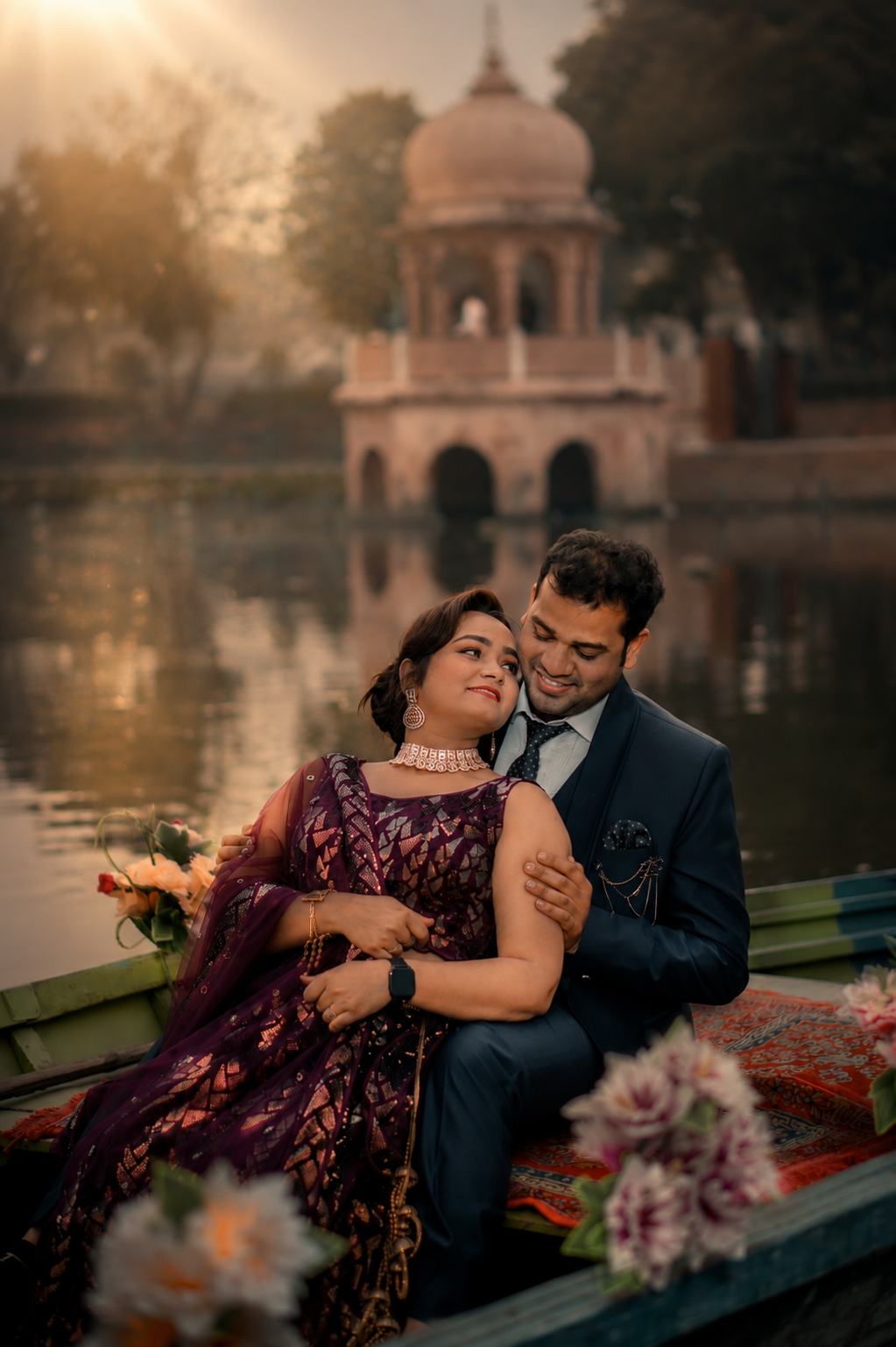 Sarita and Dharmendra on a boat in front of a Lucknow chhatri at golden hour
