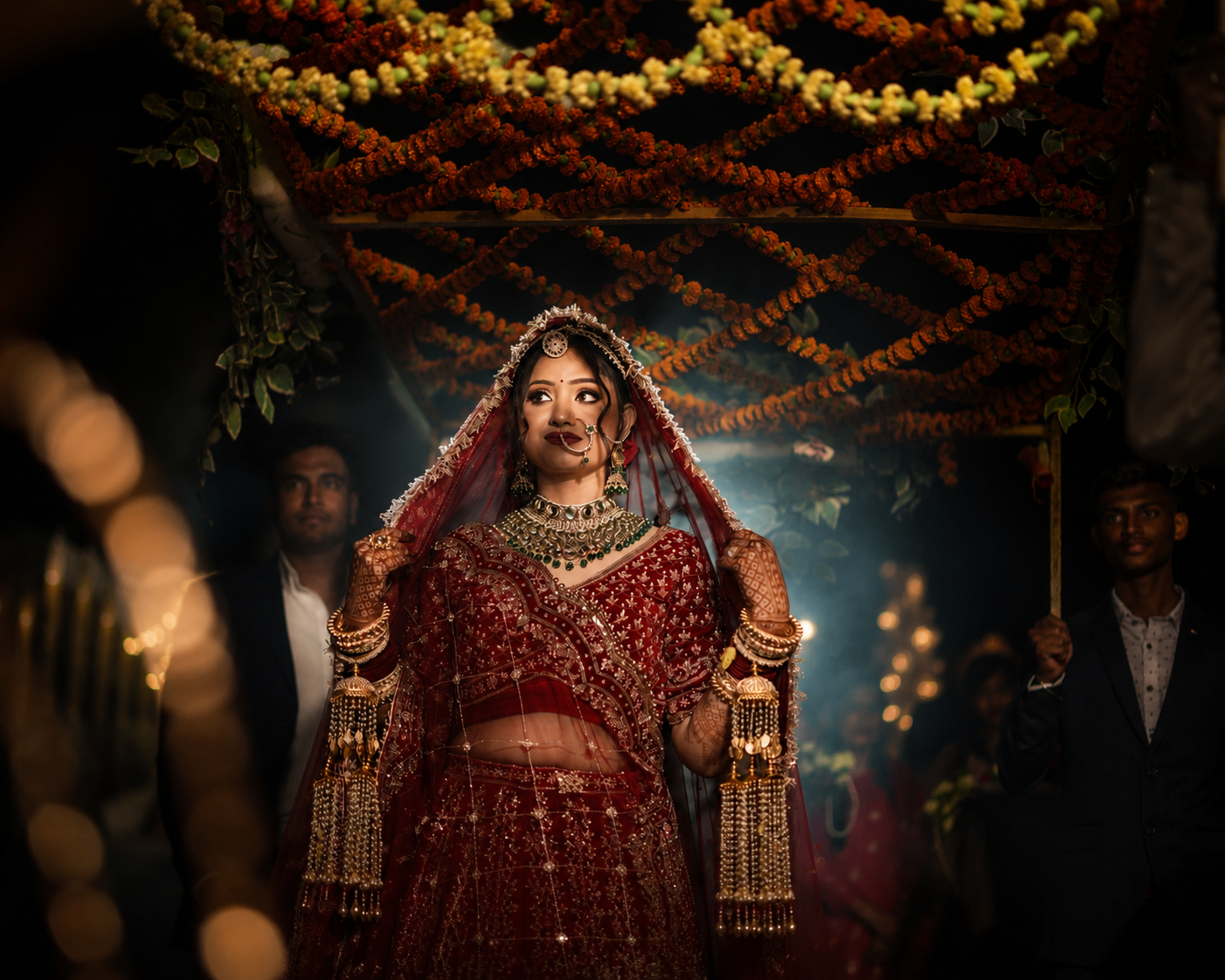 Vaishnavi beneath the marigold canopy at the Bahraich mandap, dupatta pulled softly over her head